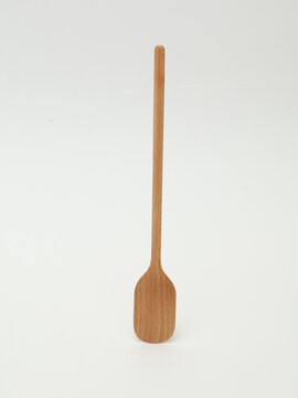 Wooden cooking spatula with long handle isolated on white background