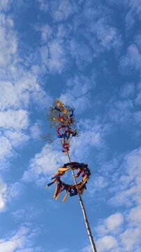 Traditional maypole decoration waving in the wind