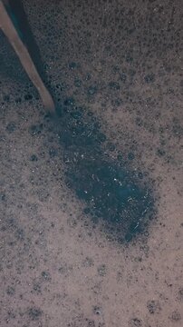 Water pouring into soapy foam bubbles spa relaxation