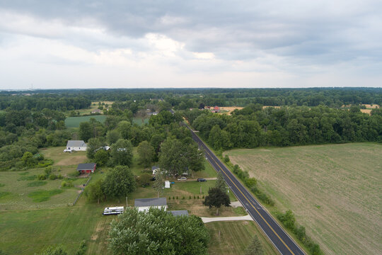 Aerial view of a rural landscape with a road and scattered houses in Michigan