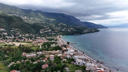 Naklejka premium Beautiful view of the vibrant Ionian sea framed by lush green pine trees on Corfu Island, Greece.
