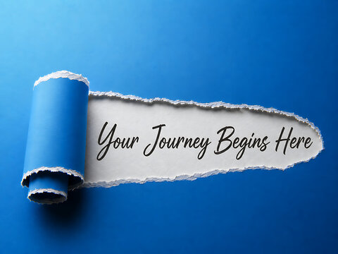Torn paper revealing text on a blue background your journey begins here concept