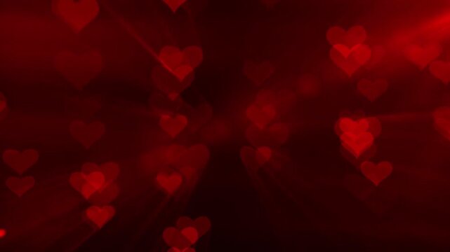 A romantic image of red hearts illuminated on a dark background, evoking feelings of love and passion. The vibrant red hues add intensity and warmth to the scene.