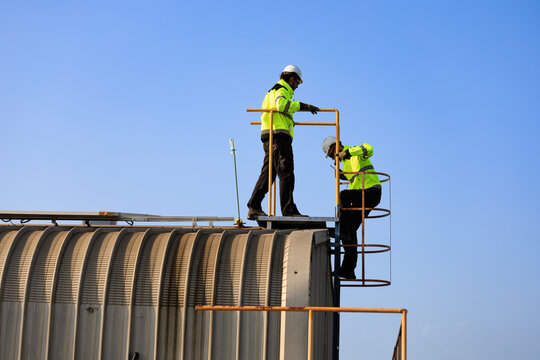 solar panel photovoltaic solarenergy electricity renewable.Technicians safely access a rooftop solar installation for inspection and maintenance, supporting reliable renewable clean electricity.