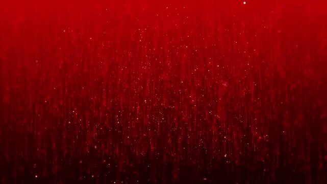 Abstract red background with falling glitter particles.