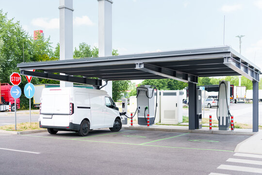 Electric commercial van charging at a modern EV charging station