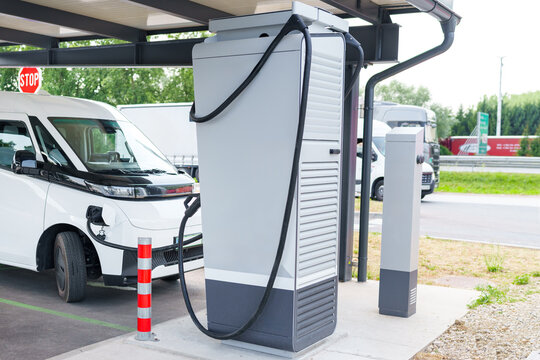 Electric commercial van charging at a modern EV charging station
