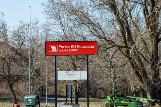 Quebec, Canada, 24 April 2026 : A red Portes RD Rousseau sign advertises garage door sales and expert services.