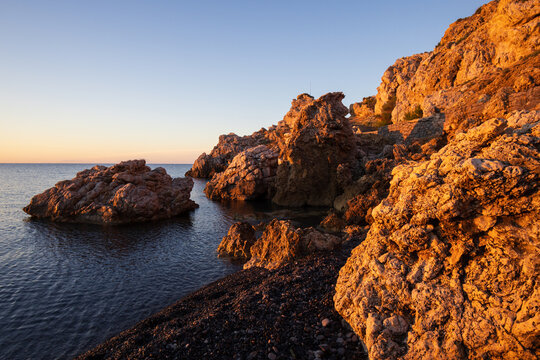  Dramatic volcanic rock formations on the unique black pebble beach of Mavra Volia in Chios