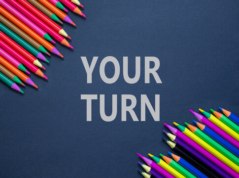 Your turn words symbol. Concept words Your turn on beautiful black paper. Beautiful black background. Beautiful colored pencils. Business your turn motivational support concept. Copy space.