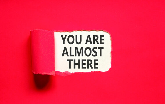 You are almost there words symbol. Concept words You are almost there on beautiful white paper. Beautiful red background. Business You are almost there motivational support concept. Copy space.