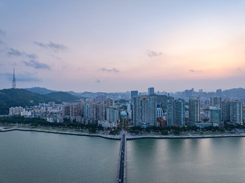 Zhuhai Sun Moon Shell city skyline at dusk with river bridge and high-rise buildings