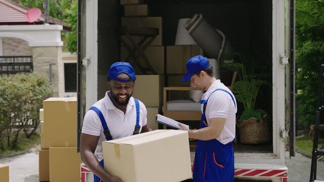 Home moving and delivery service concept. Teamwork of professional home and furniture moving with a truck from business service company. Two male movers in uniforms working and delivering to customer.