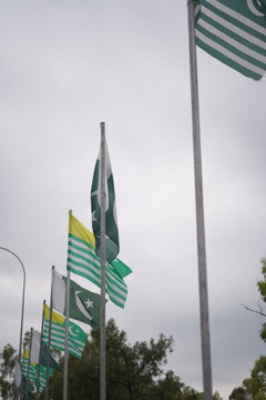 Pakistani and Kashmir flags waving on poles outdoors national unity concept