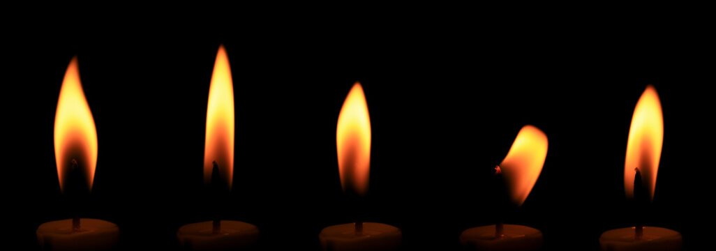 Realistic candle flame collection isolated on black background, showing burning candle light in multiple shapes for overlays, photo compositing, memorial, spiritual, decorative and religious designs.