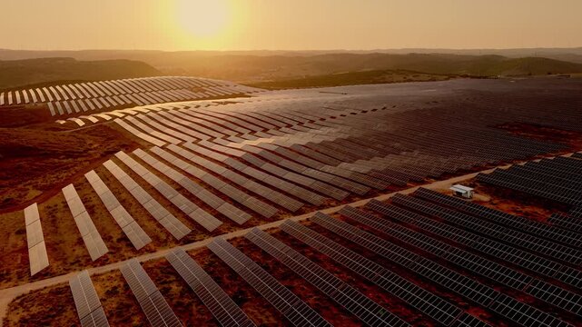 Vast photovoltaic field beneath golden evening sky