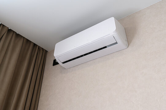 sleek white wall-mounted air conditioner with a horizontal air vent