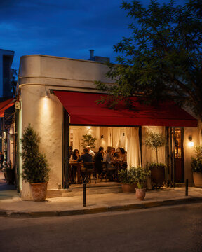 Cozy corner restaurant with a red awning at dusk