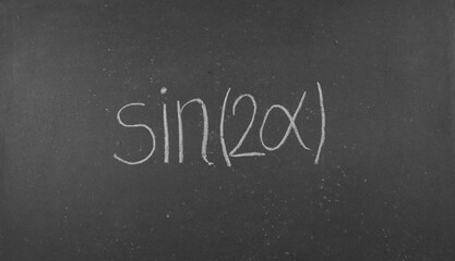 Fototapeta premium The formula for the sine of a double angle on a black school board