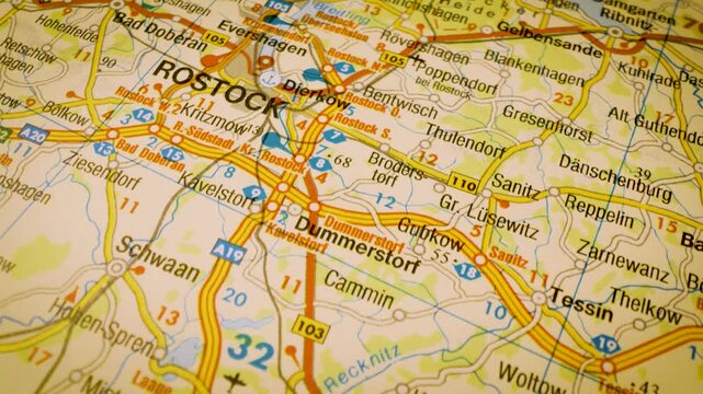 macro flight to rostock, germany, across detailed road atlas map