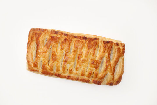 Crispy golden rectangular puff pastry slice isolated on clean white backdrop. Delicious freshly baked Danish strudel pie perfect for coffee shop menu, morning breakfast, dessert, or sweet snack.