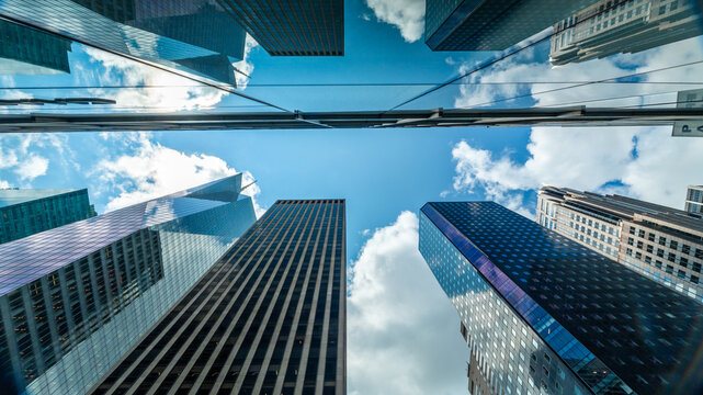Modern Glass Skyscrapers Reflecting Blue Sky in Urban Financial District
