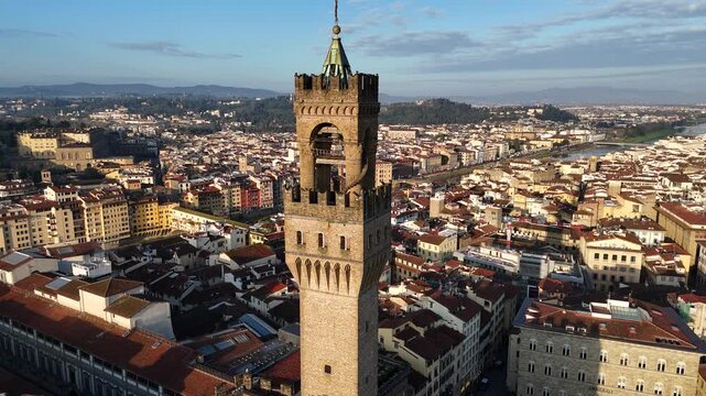 Cinematic drone 360 degree orbit shot circling Arnolfo tower of Palazzo Vecchio Florence
