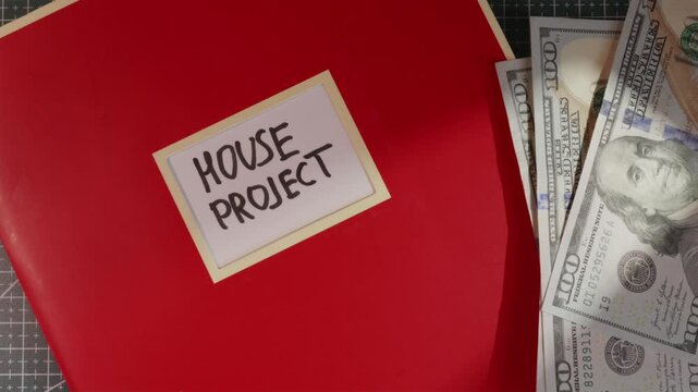 House Project red folder with US dollar cash flat lay