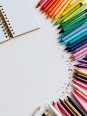 Fototapeta premium Colorful Colored Pencils and Notebook Flat Lay Background with Copy Space