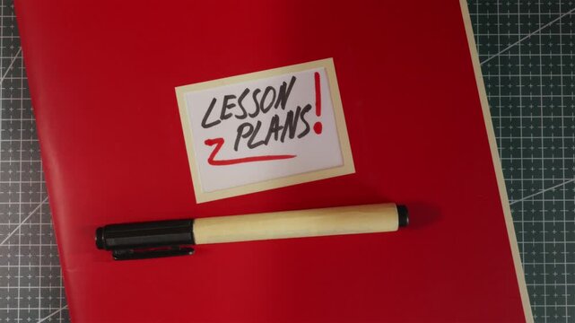 Wide establishing shot of Lesson Plans red teacher binder