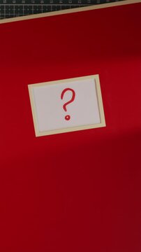 Red notebook with question mark label top down view