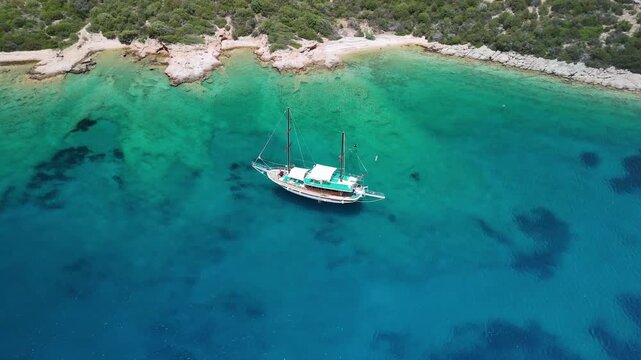 Traditional Turkish gulet anchored in crystal clear turquoise bay near Bodrum Turkey