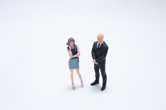 Miniature business couple standing together dressed