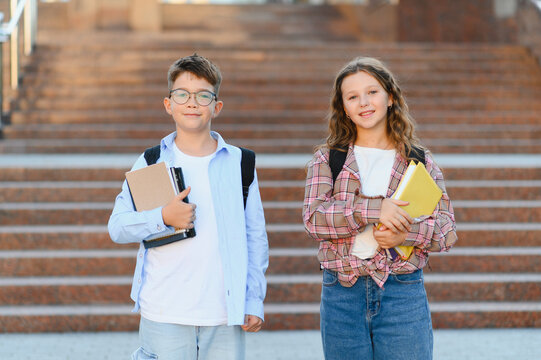 Schoolchildren ready for lessons studying university campus