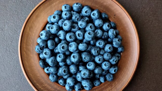 Fresh, ripe, and juicy wild blueberries as an ingredient for vegetarian dishes. Blueberries as a food background for your design
