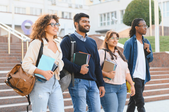 Diverse students walking on university campus together