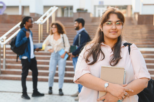 Young indian student smiling on university campus