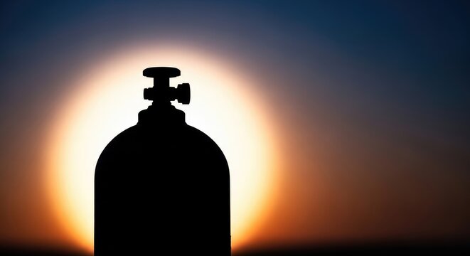 Silhouette of a Gas Cylinder Against a Vibrant Sunset Sky.