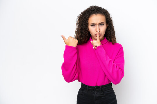 Young Arab woman isolated on white background pointing to the side and doing silence gesture