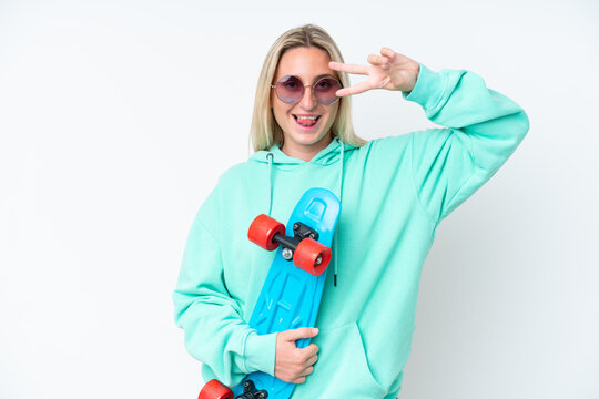 Young caucasian woman isolated on white background with a skate with happy expression