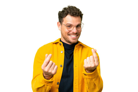 Brazilian man over isolated chroma key background making money gesture