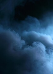 Fototapeta premium Close-up of a dark blue smoke or fog. the smoke appears to be thick and fluffy, with a smooth texture. the background is completely black, making the smoke stand out even more.