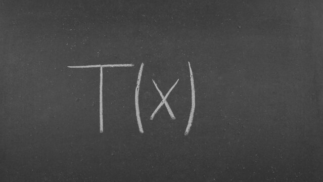 Mathematical notation of the function T(x) written in chalk on a blackboard