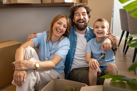 Family enjoys time together while unpacking boxes in a new home