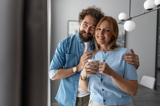 Couple enjoying coffee together in a modern kitchen during a bright morning