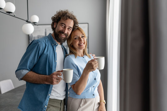 Couple enjoying coffee together in a modern kitchen during morning hours