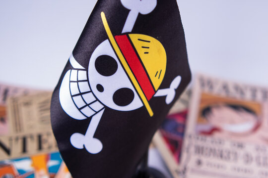 Riau, August 1, 2026, Close-up of One Piece pirate flag with Straw Hat crew wanted posters in the background. Ideal anime-themed visual for fans, collectors, or creative editorial use
