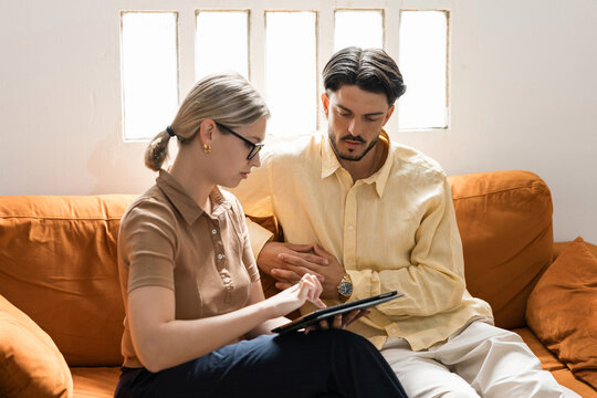Couple discussing content together using digital tablet