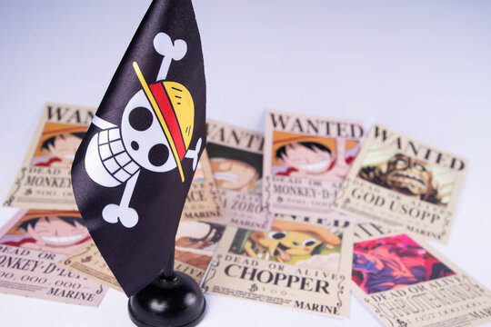 Riau, August 1, 2026, Close-up of One Piece pirate flag with Straw Hat crew wanted posters in the background. Ideal anime-themed visual for fans, collectors, or creative editorial use