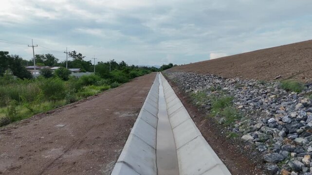 Cement canals are used to drain water from high roadsides in rural areas.